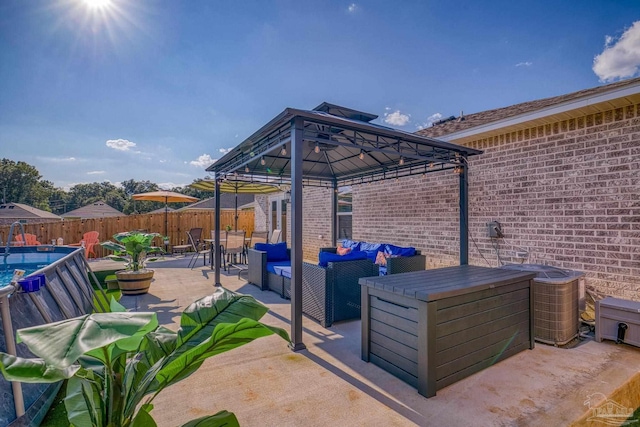 view of patio / terrace featuring a gazebo, a fenced backyard, and an outdoor living space