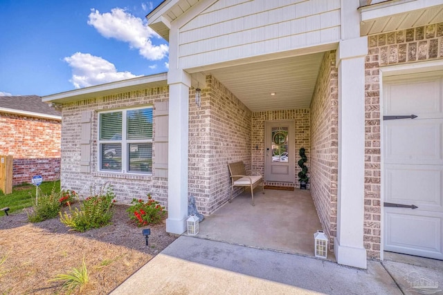 view of exterior entry with brick siding