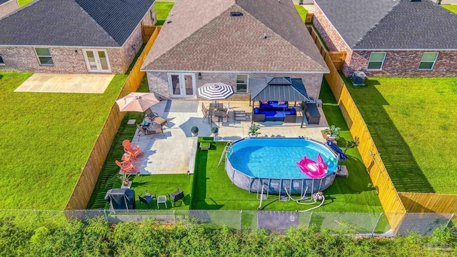 view of pool with a fenced in pool, a yard, a gazebo, cooling unit, and a fenced backyard