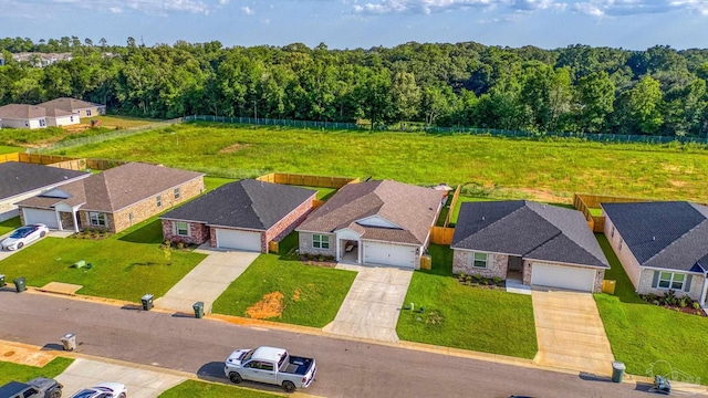 drone / aerial view featuring a residential view and a wooded view