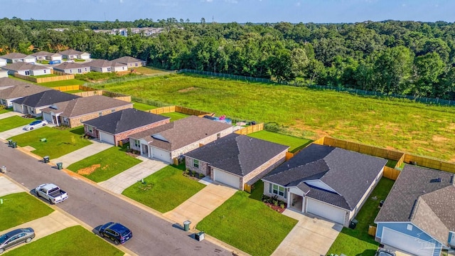 drone / aerial view with a forest view and a residential view