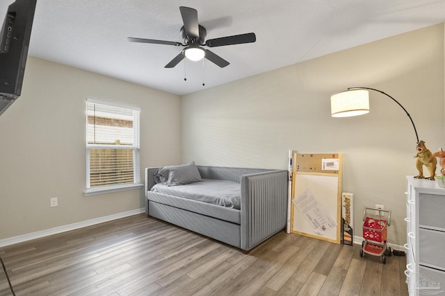 bedroom with baseboards and wood finished floors