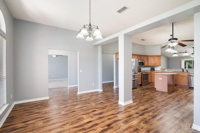 7292 Broadmoor St, Navarre, FL 32566 - kitchen featuring appliances with stainless steel finishes, open floor plan, dark wood-style floors, and a chandelier