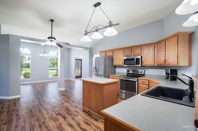 7292 Broadmoor St, Navarre, FL 32566 - kitchen with stainless steel appliances, a center island, a ceiling fan, light countertops, and dark wood finished floors