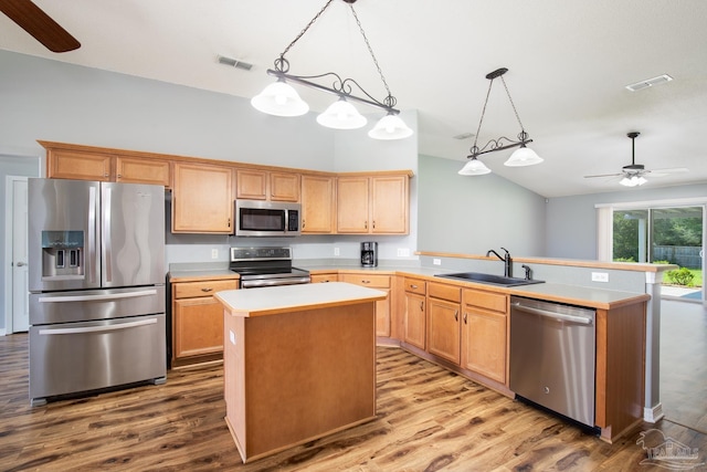 7292 Broadmoor St, Navarre, FL 32566 - kitchen with stainless steel appliances, vaulted ceiling, a ceiling fan, wood finished floors, and light countertops