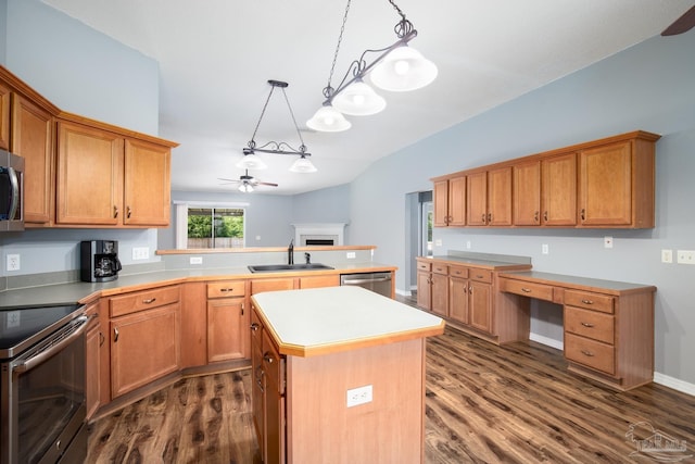7292 Broadmoor St, Navarre, FL 32566 - kitchen with stainless steel appliances, a fireplace, ceiling fan, dark wood-type flooring, and a peninsula