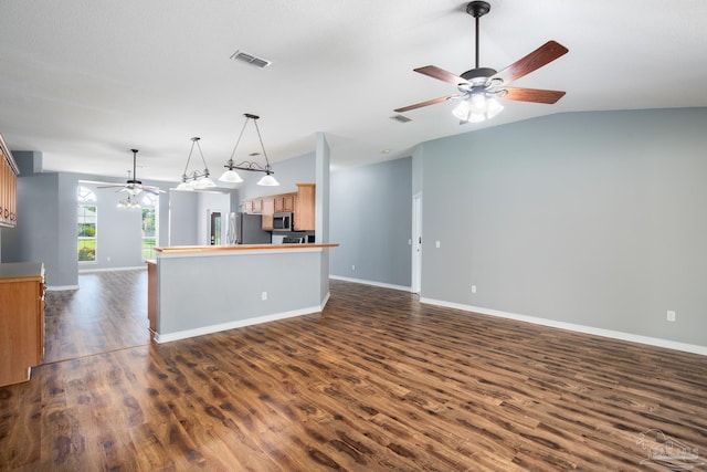 7292 Broadmoor St, Navarre, FL 32566 - kitchen featuring open floor plan, ceiling fan, appliances with stainless steel finishes, dark wood-style floors, and brown cabinetry