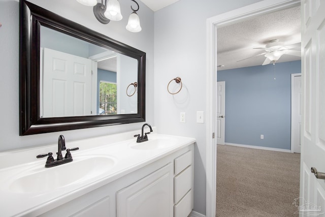7292 Broadmoor St, Navarre, FL 32566 - bathroom featuring double vanity, a ceiling fan, and a textured ceiling