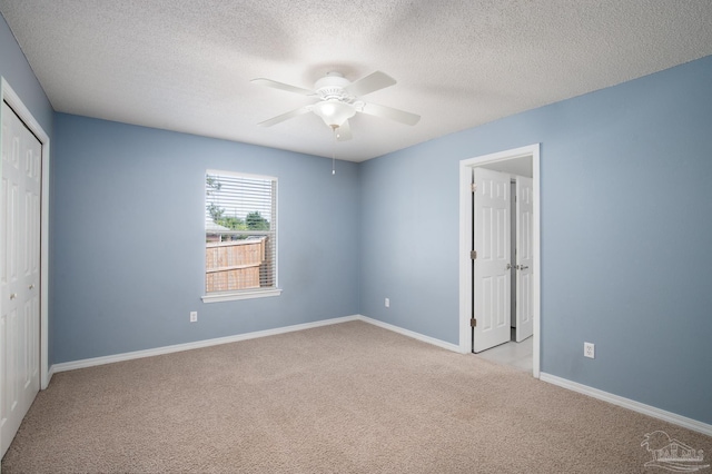 7292 Broadmoor St, Navarre, FL 32566 - unfurnished bedroom with carpet flooring, a closet, a textured ceiling, and ceiling fan