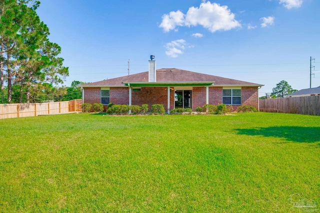 7292 Broadmoor St, Navarre, FL 32566 - back of property featuring a fenced backyard, brick siding, and a chimney