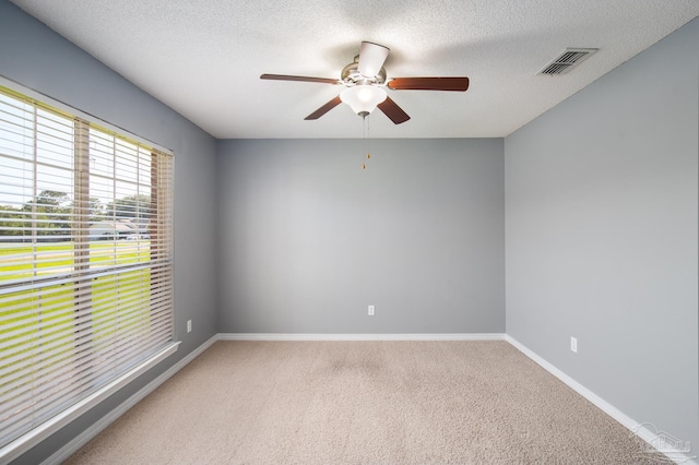 7292 Broadmoor St, Navarre, FL 32566 - unfurnished room with light colored carpet, a ceiling fan, and a textured ceiling