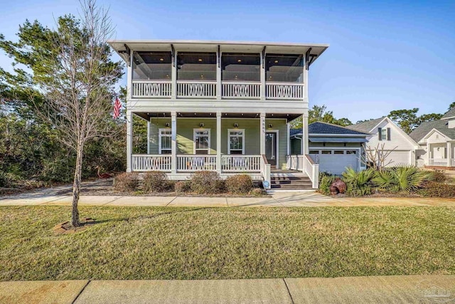 view of front of house featuring a porch, a sunroom, an attached garage, and a front lawn