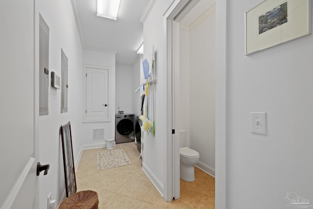 bathroom with baseboards, visible vents, toilet, tile patterned flooring, and crown molding