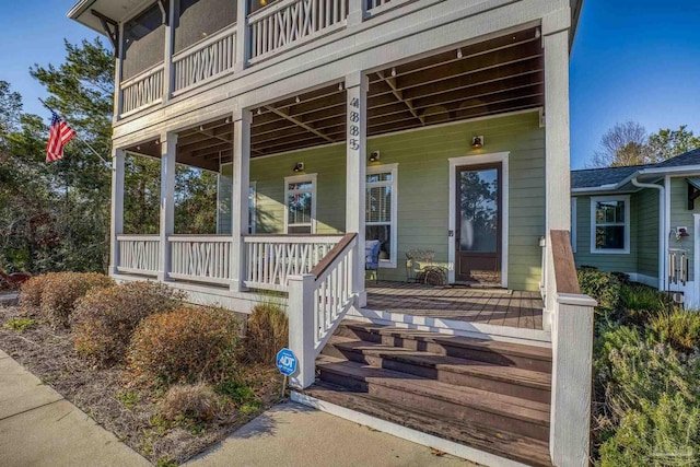 view of exterior entry with covered porch