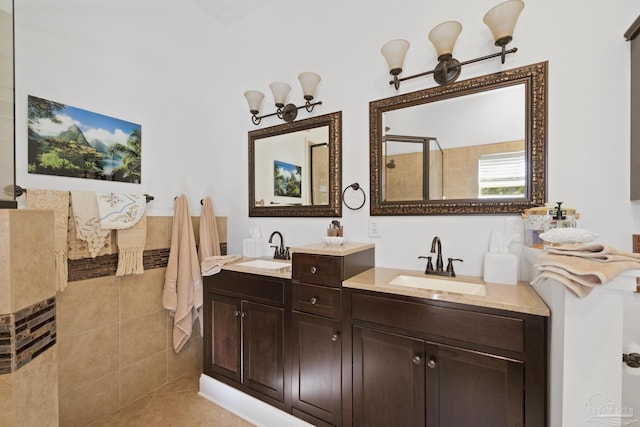 bathroom featuring tiled shower, vanity, and tile patterned floors