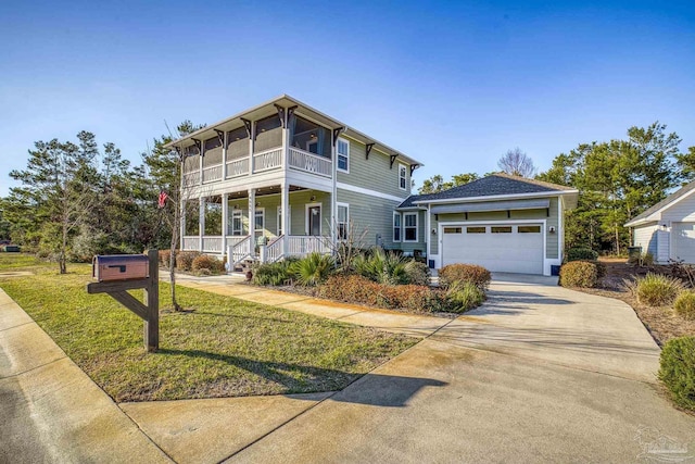 view of front of property featuring driveway, a garage, a front lawn, and a porch