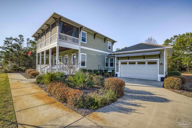 view of front of property featuring driveway, a garage, and a porch