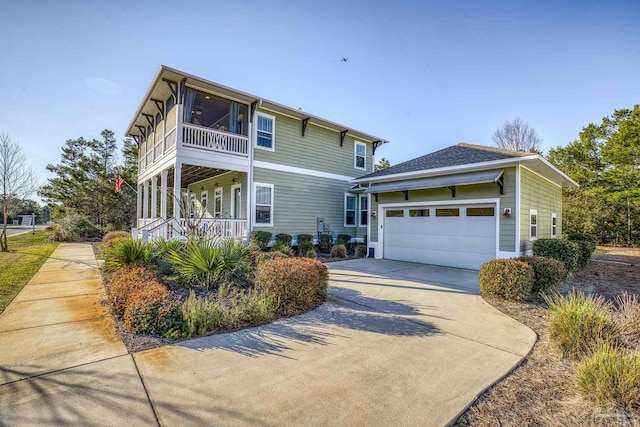 view of front of property featuring driveway, a sunroom, and an attached garage