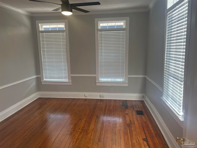 spare room with ceiling fan, dark hardwood / wood-style floors, ornamental molding, and a healthy amount of sunlight