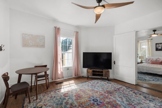 living room featuring ceiling fan and hardwood / wood-style floors