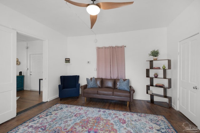 living room with ceiling fan and dark hardwood / wood-style flooring