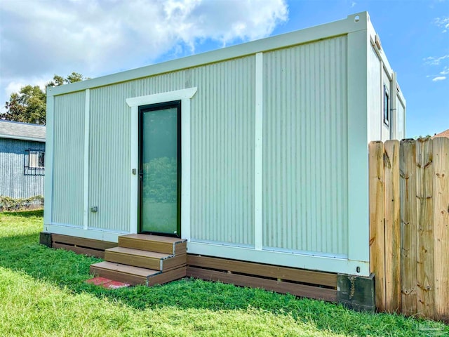 view of outbuilding featuring a yard