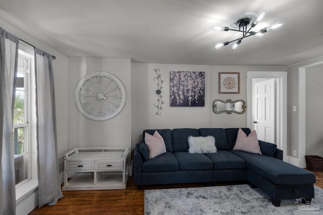 living room with a notable chandelier and hardwood / wood-style flooring