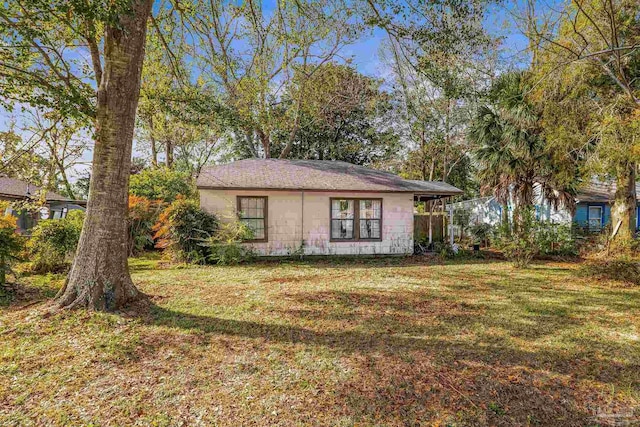 view of side of home featuring a lawn