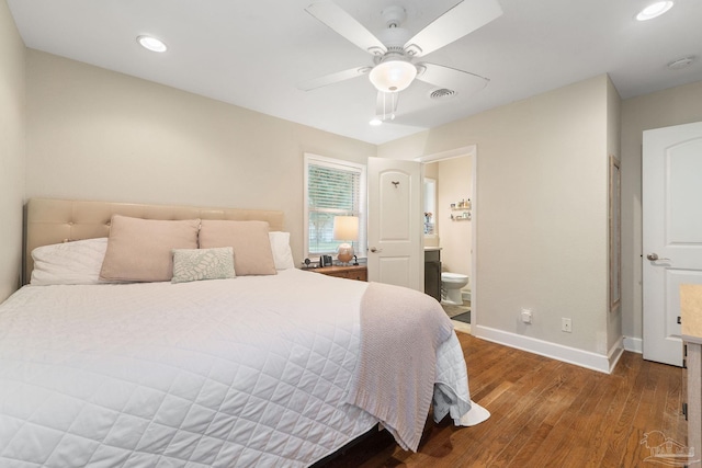 bedroom featuring hardwood / wood-style floors, ceiling fan, and ensuite bath