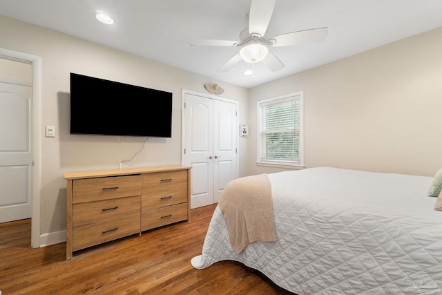 bedroom featuring ceiling fan, a closet, and light hardwood / wood-style flooring