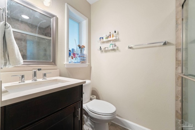 bathroom featuring vanity, toilet, and a shower with shower door