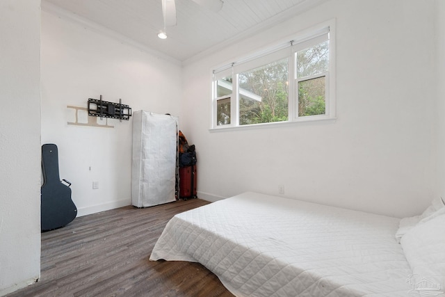 bedroom featuring wood-type flooring, ceiling fan, and crown molding