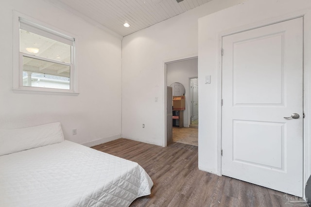 bedroom with dark wood-type flooring