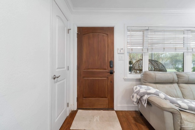 entryway with dark wood-type flooring and ornamental molding