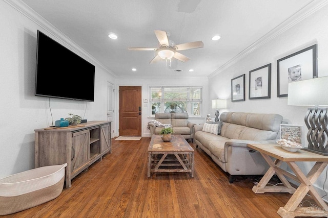 living room with ornamental molding, dark wood-type flooring, and ceiling fan