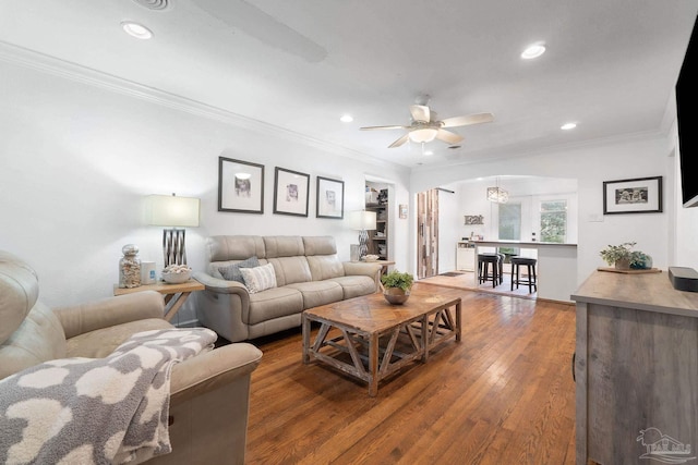 living room with ceiling fan, hardwood / wood-style flooring, and ornamental molding