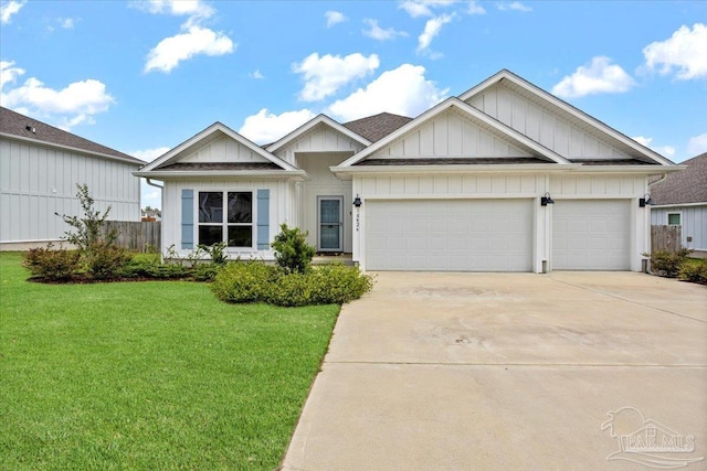 10826 Blacktail Loop, Pensacola, FL 32526 - view of front of house with board and batten siding, driveway, a front yard, and a garage