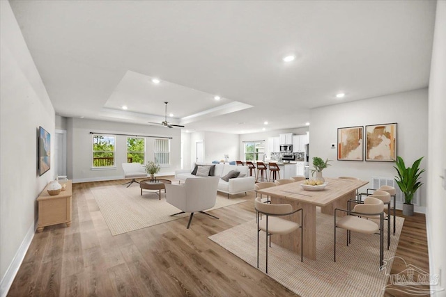 10826 Blacktail Loop, Pensacola, FL 32526 - dining space featuring plenty of natural light, light wood-type flooring, baseboards, a raised ceiling, and recessed lighting