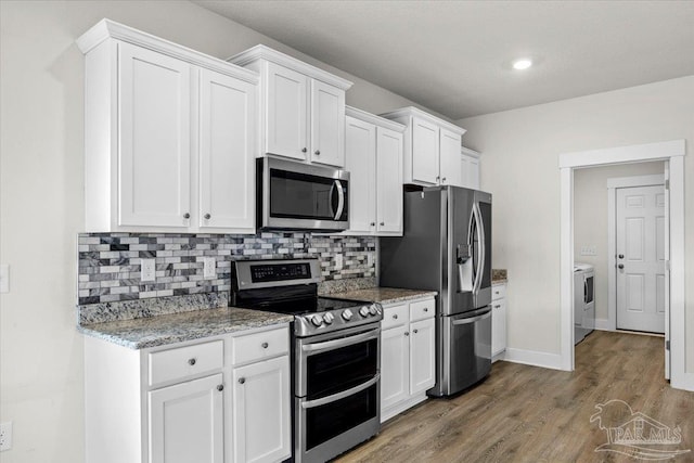 10826 Blacktail Loop, Pensacola, FL 32526 - kitchen with appliances with stainless steel finishes, white cabinets, tasteful backsplash, light wood finished floors, and recessed lighting