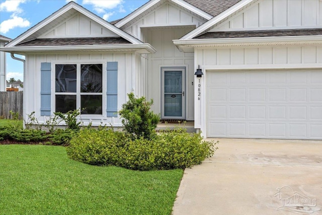 10826 Blacktail Loop, Pensacola, FL 32526 - view of front facade featuring concrete driveway, board and batten siding, an attached garage, and a front lawn