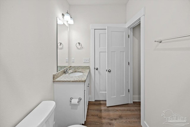 10826 Blacktail Loop, Pensacola, FL 32526 - bathroom with wood finished floors, toilet, and vanity