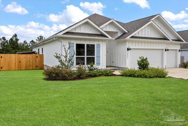 10826 Blacktail Loop, Pensacola, FL 32526 - view of front of home featuring board and batten siding, an attached garage, concrete driveway, and a shingled roof