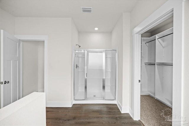 10826 Blacktail Loop, Pensacola, FL 32526 - bathroom featuring a shower stall, wood finished floors, a walk in closet, baseboards, and recessed lighting