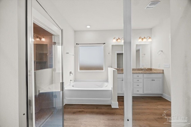 10826 Blacktail Loop, Pensacola, FL 32526 - bathroom with vanity, a bath, wood finished floors, and a stall shower
