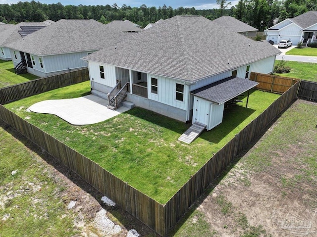 10826 Blacktail Loop, Pensacola, FL 32526 - view of front of house featuring roof with shingles, a patio area, and board and batten siding