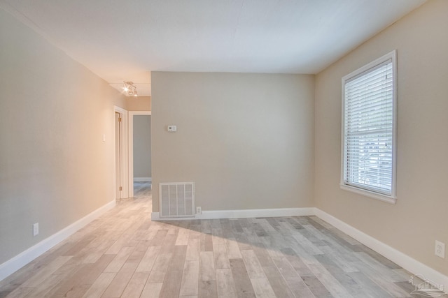 empty room with light hardwood / wood-style flooring