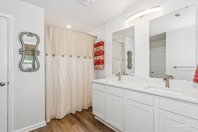 bathroom featuring vanity and hardwood / wood-style floors