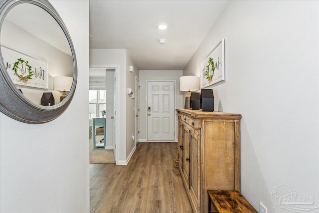 hall with hardwood / wood-style floors