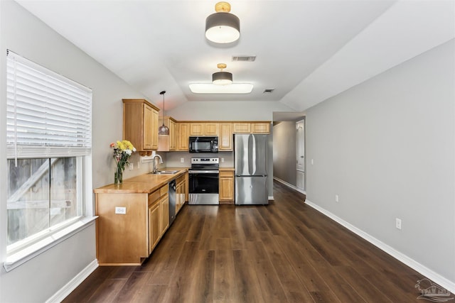 kitchen with visible vents, a sink, light countertops, stainless steel appliances, and dark wood-type flooring