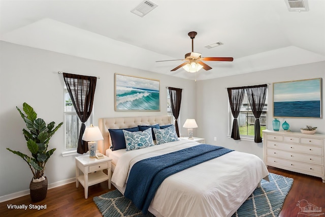 bedroom with dark wood-type flooring, visible vents, and baseboards